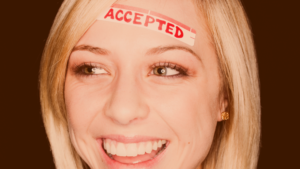 Woman smiling with the word accepted on her forehead